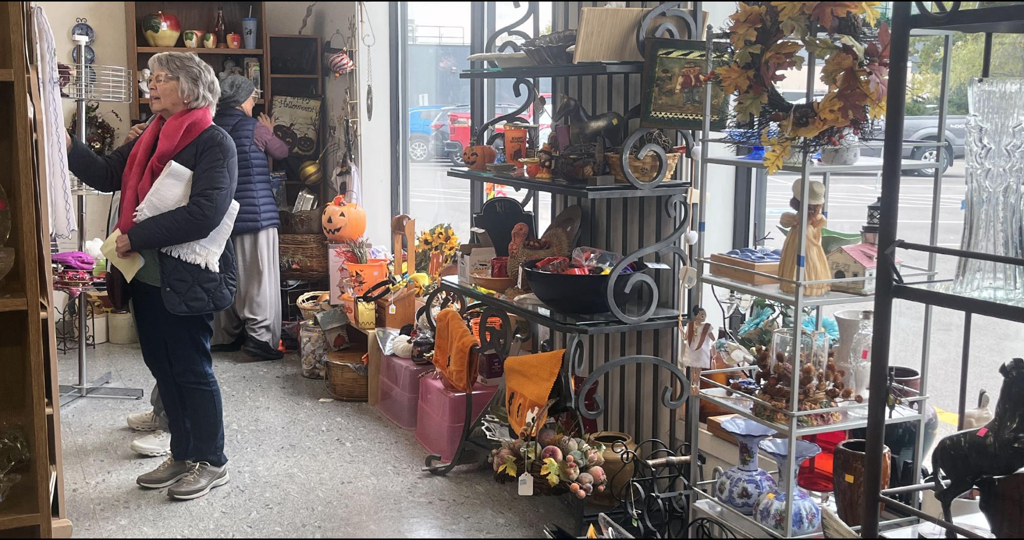 Woman looking at items at front of Used a Bit Store